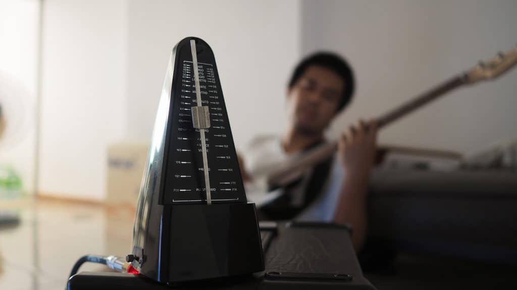 Black metronome is used by musician to keep a steady tempo