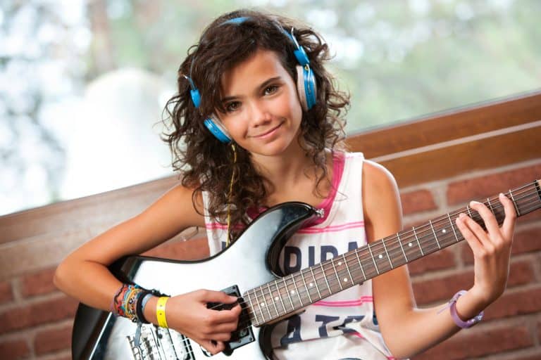 Cute girl with electric guitar