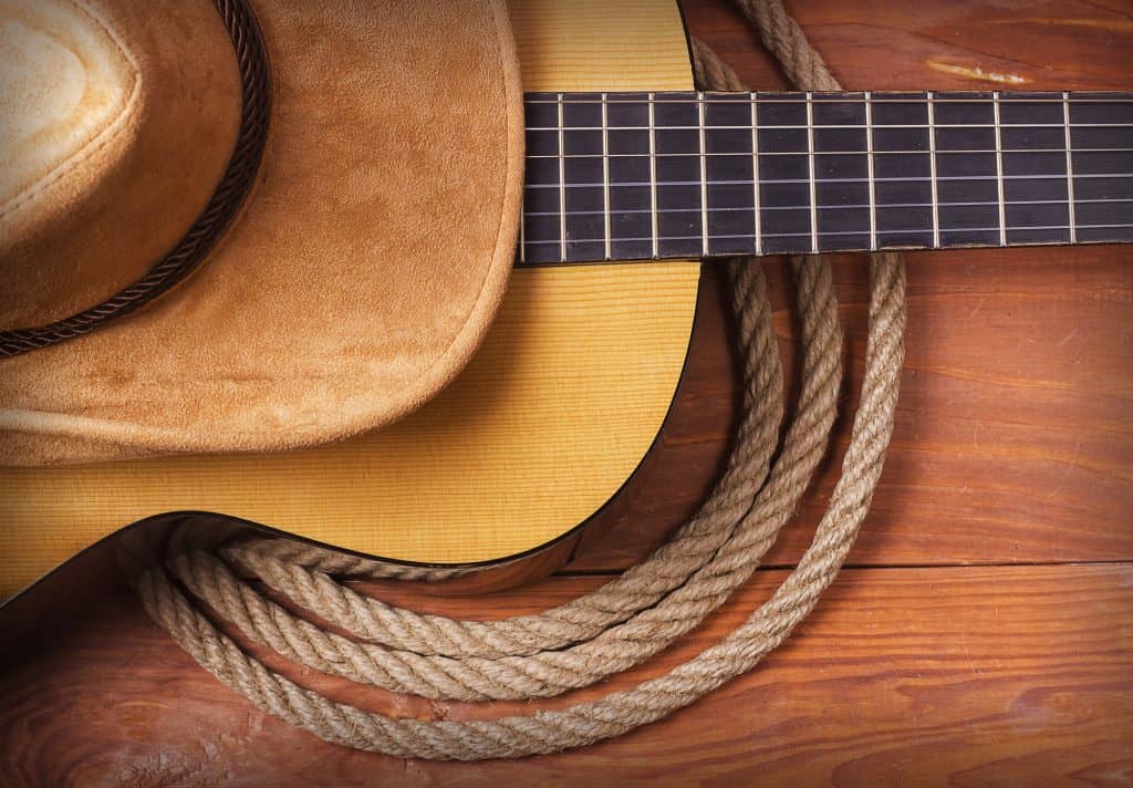 guitar with a cowboy hat and rope