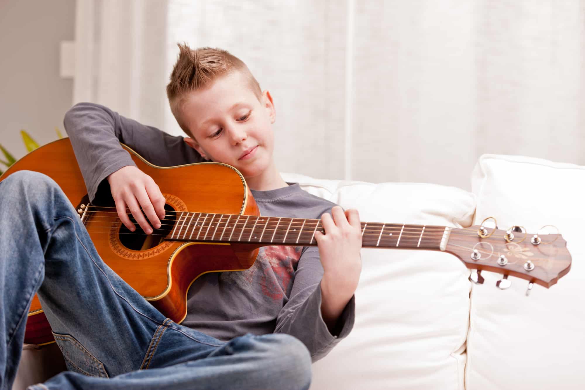 5 Best Acoustic Guitars For Kids In 2023 Instrumentio   Little Boy Playing Guitar At Home 