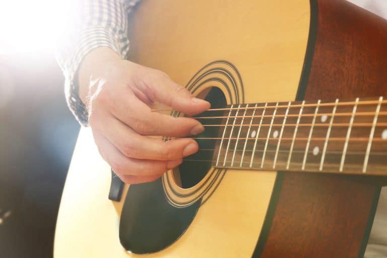 Man playing fingerstyle acoustic guitar